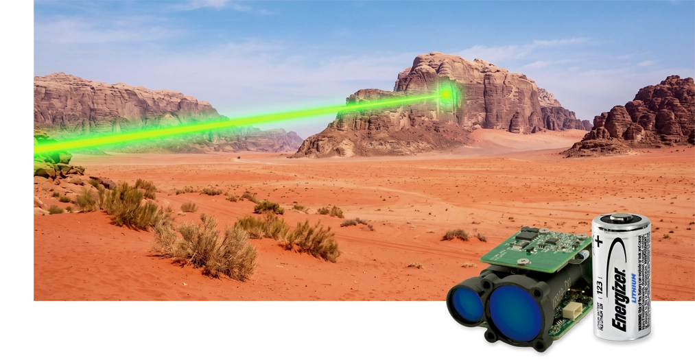 Picture of a laser beam shooting across the desert with the LRF2 and battery in the foreground.